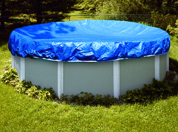 Above ground pool covered by blue fitted Winter cover