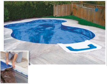 Underground pool covered by blue fitted tarp cover in Winter
