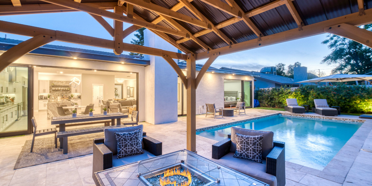 Outdoor seating area with Pool in the background 