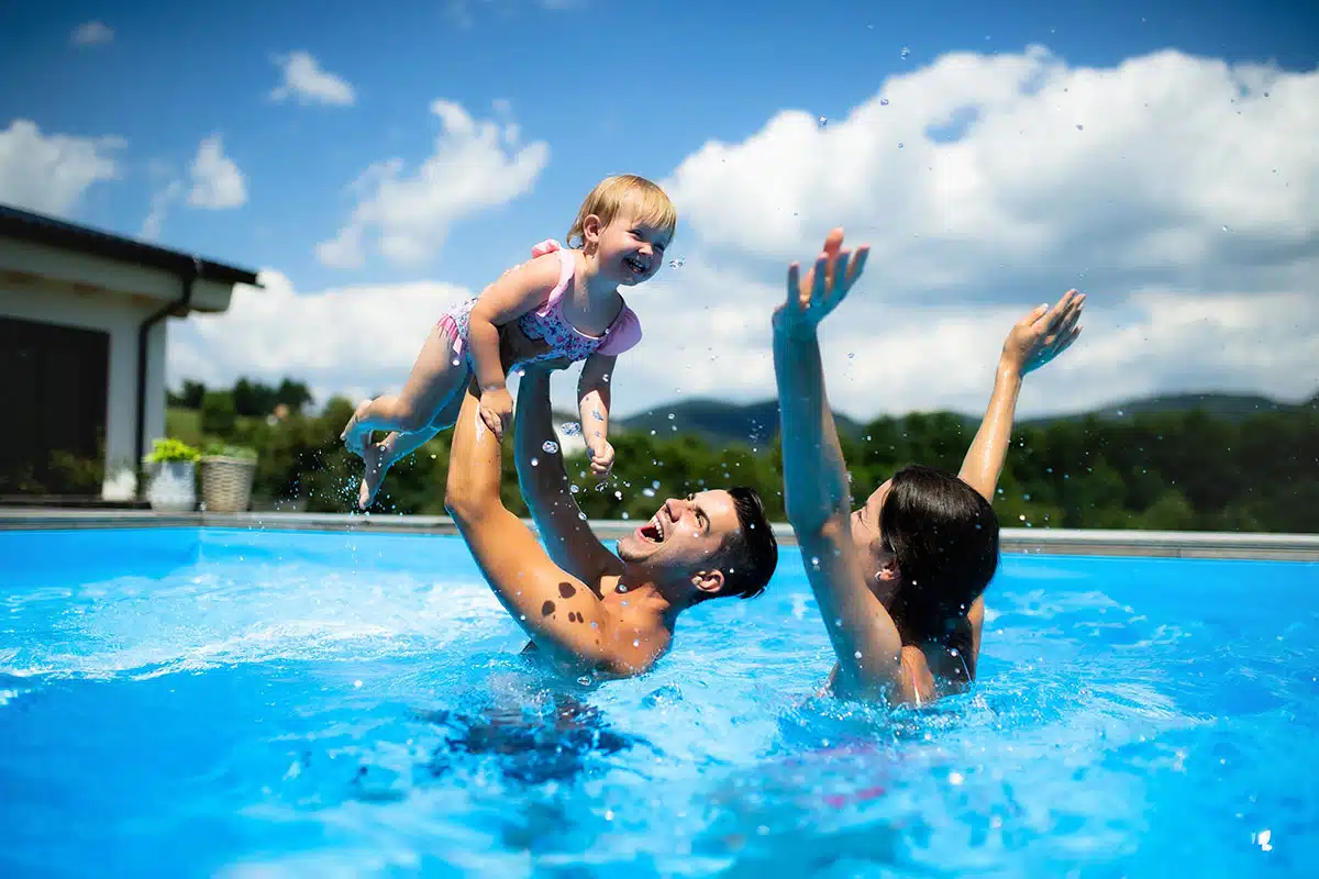Family Playing In Pool Child 2