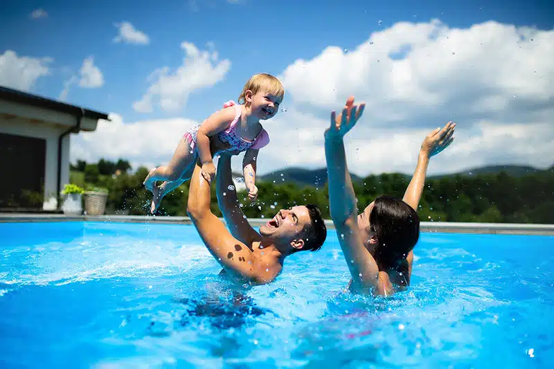Family Playing In Pool Child 3